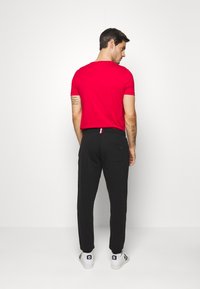 Tommy Hilfiger LOGO - Pantalon de survêtement - black